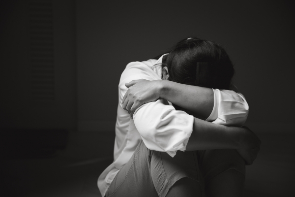 woman on floor with arms wrapped