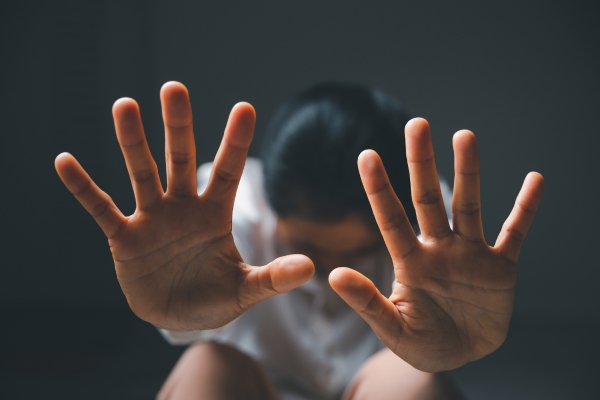 woman on ground with her hands up