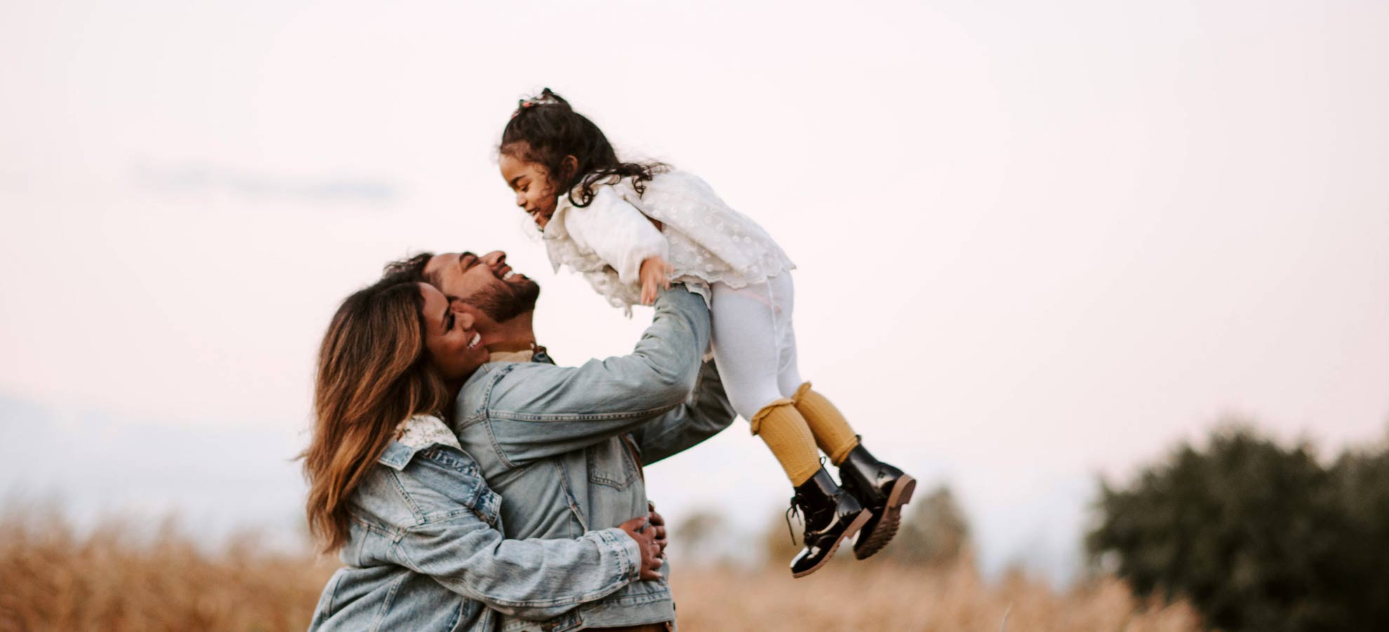 Family laughing in a park