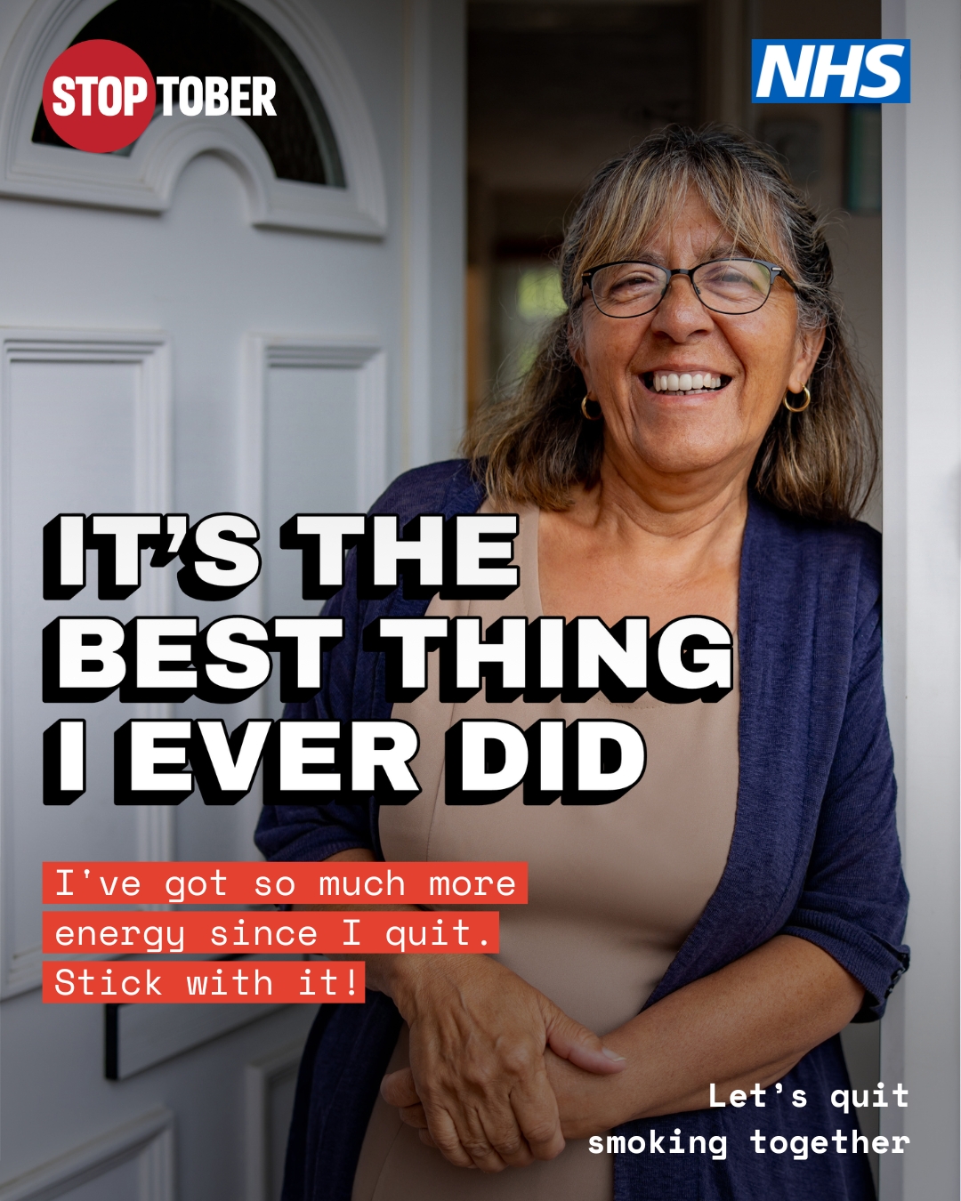 lady leaning against door smiling 