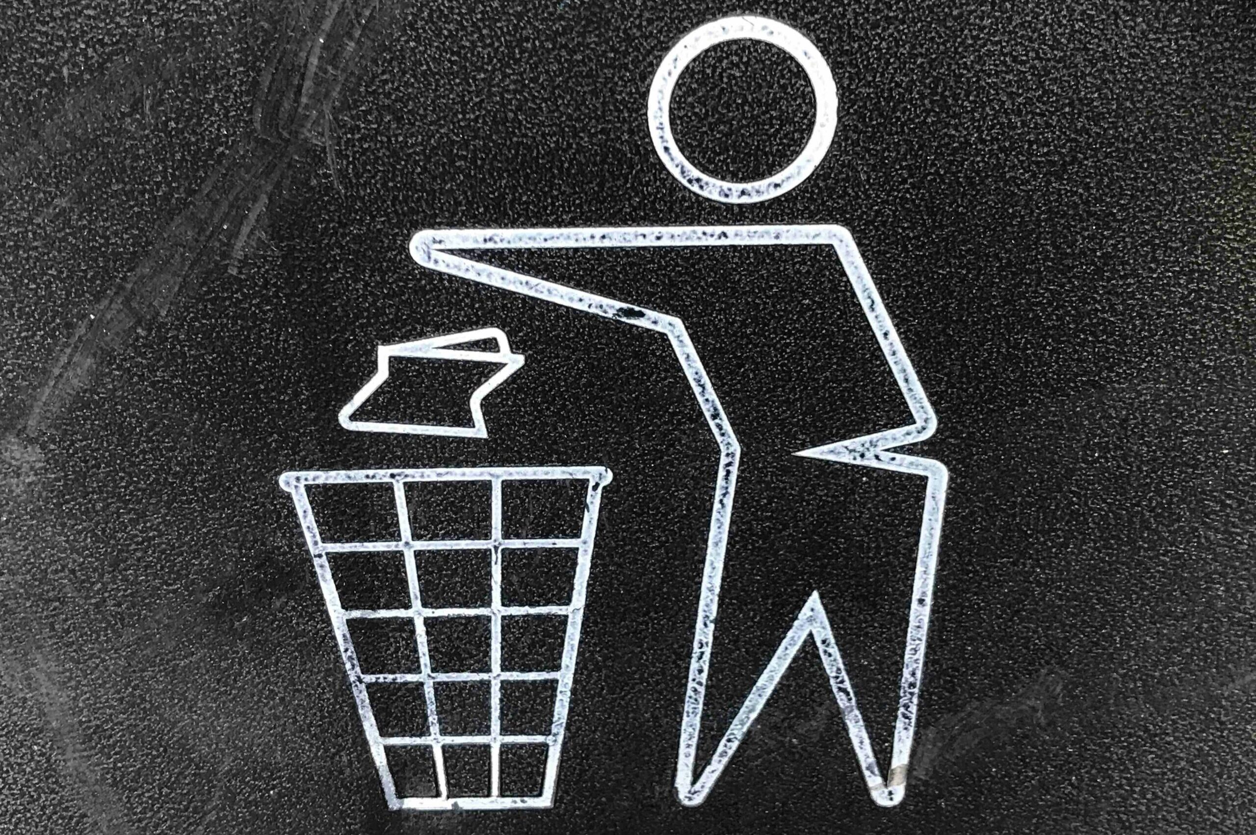 cartoon figure placing litter in a bin