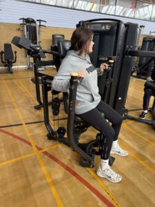 woman uses exercise equipment in the gym