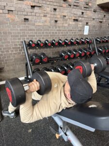 man lifts weights in the gym
